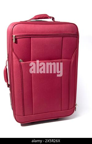Closed red suitcase isolated on white background with empty space for text from the side view Stock Photo