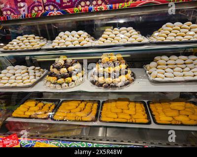 Cairo, Egypt, March 24 2024: Traditional Arabic cookies for celebration of Islamic holidays El-Fitr feast, Egyptian Ghoriba, Egyptian Kahk with powder Stock Photo