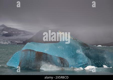 Glacier ice shimmering in various shades of blue near the edge of Negribreen, Stjorfjord, Spitsbergen Island, Svalbard and Jan Mayen archipelago Stock Photo