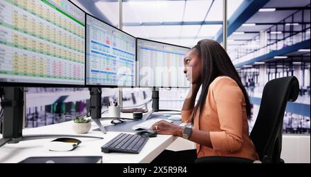Data Analyst African Woman Using Spreadsheet On Computer Stock Photo