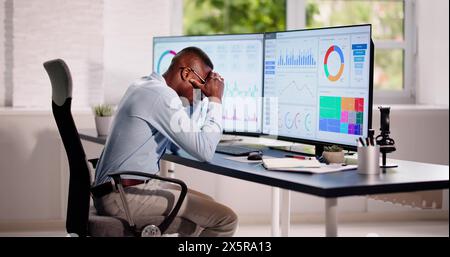 Data Analyst African Man Using Spreadsheet On Computer Stock Photo