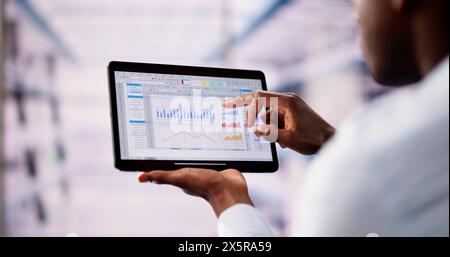 Professional Analyst Employee Using Spreadsheet Data On Laptop Computer Stock Photo