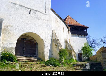 Gate of the fortified Viscri church and watchtower (Transylvania, Romania). Architecture of a UNESCO World Heritage Site Stock Photo