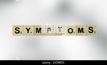 symptoms word written on wood block. symptoms text on table, concept ...