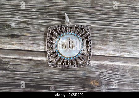 Translation of the Arabic Text (Allah, God) on a silver precious metal piece with precious stones, exchange rate marketing and value, business, price Stock Photo
