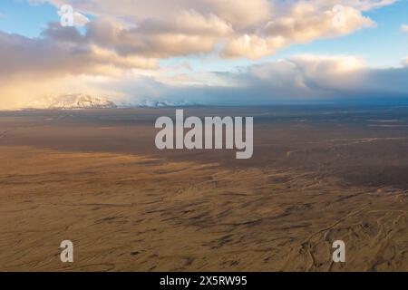 Sunset drone view of volcanic valley with mountain peaks covered with snow. East Iceland Stock Photo
