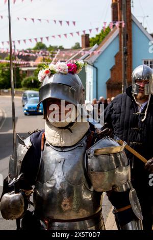 Medieval re-enactment group the Suffolk Knights having attended an 'individual' wedding at the Unitarian church in Framlingham walk through the town Stock Photo