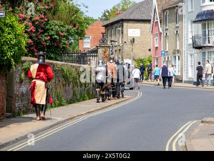 Medieval re-enactment group the Suffolk Knights having attended an 'individual' wedding at the Unitarian church in Framlingham walk through the town Stock Photo