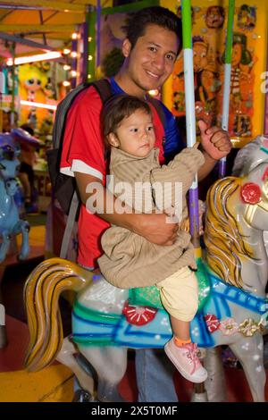Oaxaca, Mexico, North America.  Day of the Dead Celebrations.  Carosel (Merry-go-round) Amusement Ride outside entrance to San Miguel Cemetery. Stock Photo