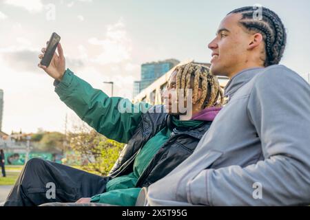 Young male friends taking selfie outdoors Stock Photo