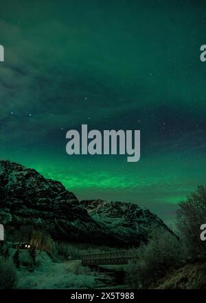 Northern lights over snowy mountains, Tromso, Norway Stock Photo