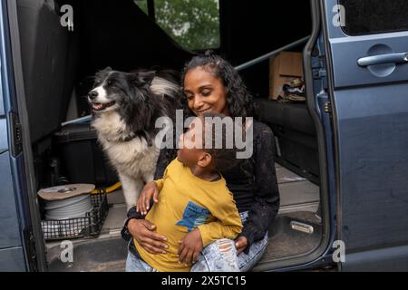 Mother with son and dog in van preparing for trip Stock Photo
