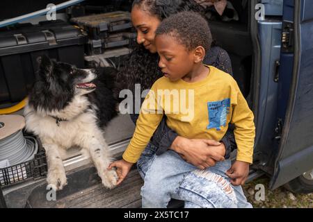 Mother with son and dog in van preparing for trip Stock Photo