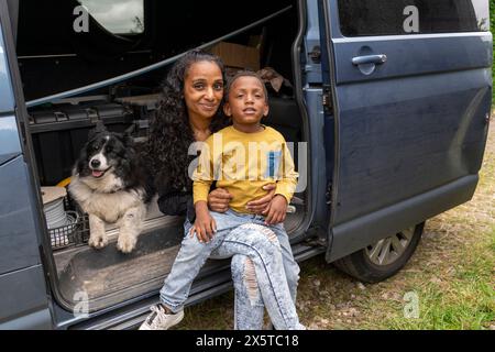 Portrait of mother with son and dog in van preparing for trip Stock Photo