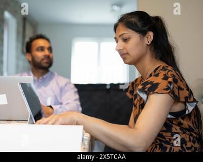 Couple working from home on tablet and laptop Stock Photo