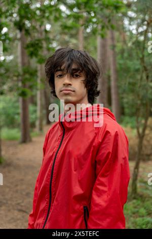 Portrait of young man hiking in forest Stock Photo