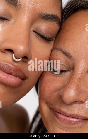 Close-up of two women with eyes closed Stock Photo