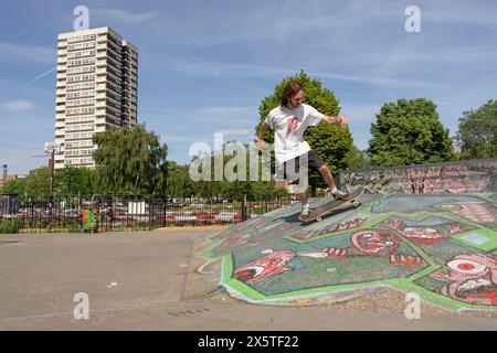 Young man skateboarding in skate park Stock Photo
