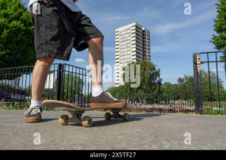 Young man skateboarding in skate park Stock Photo