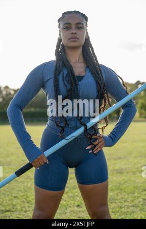 Portrait of confident female athlete holding javelin Stock Photo