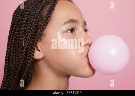 Close-up of girl blowing bubble gum Stock Photo