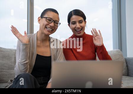 Coworkers having online meeting in office lobby Stock Photo