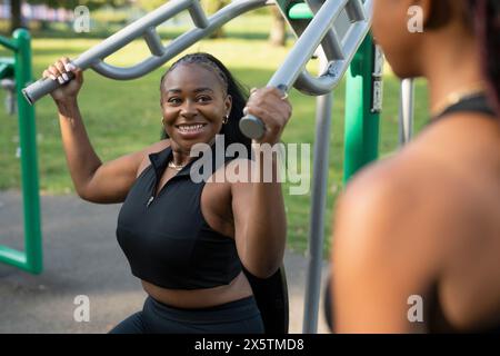 Young women exercising in outdoor gym Stock Photo