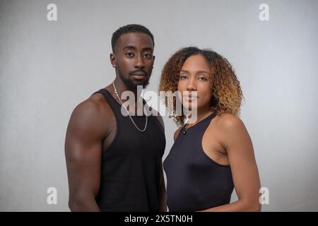 Portrait of couple wearing black tank tops Stock Photo