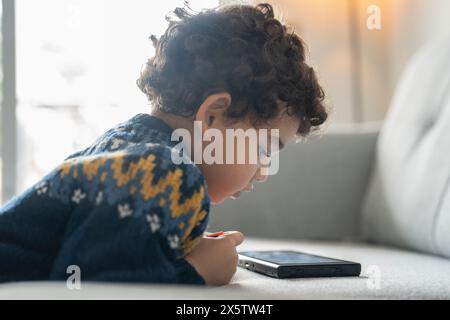 Boy (2-3) using digital tablet at home Stock Photo