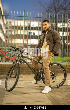 Portrait of young man on bicycle Stock Photo