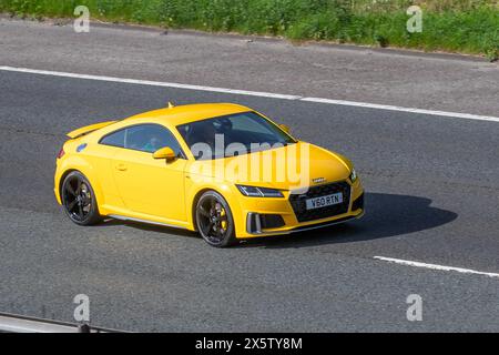 2019 Yellow Audi TT S Line 45 TFSI Quattro motoring on the M61 motorway, UK Stock Photo