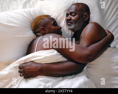 UK, Overhead view of mature couple sleeping in bed Stock Photo
