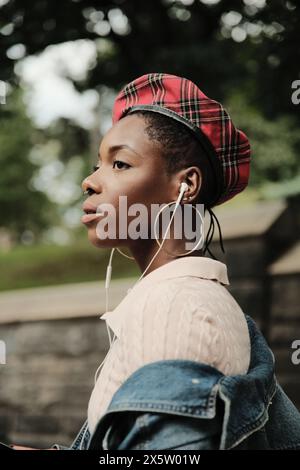 USA, New York, Profile of stylish woman with earbuds Stock Photo