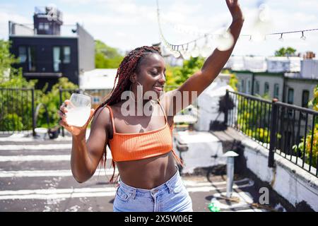 Smiling woman with drink outdoors Stock Photo