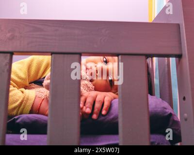 Smiling boy lying in bed Stock Photo