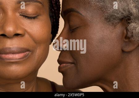Close-up of two women with eyes closed Stock Photo