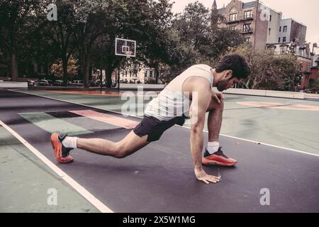 USA, Pennsylvania, Philadelphia, Man stretching in park Stock Photo