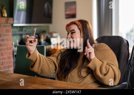Woman in wheelchair taking selfie Stock Photo