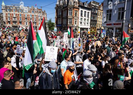 AMSTERDAM - Participants of a demonstration 'Stop genocide in Gaza' in the context of the Nakba walk on the Muntplein in Amsterdam. With Nakba, Palestinians commemorate the expulsion of hundreds of thousands of Arabs at the time of the establishment of the state of Israel in 1948. ANP MICHEL VAN BERGEN netherlands out - belgium out Stock Photo