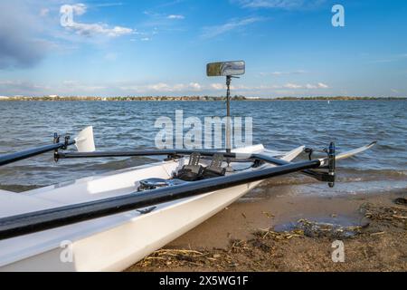 Rowing shell with a mirror on a sandy shore, Boyd Lake State Park in spring scenery. Stock Photo