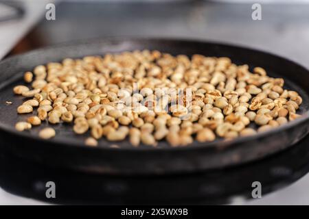 Ethiopian roasting of green coffee beans until black. Aromatic natural coffee made from freshly roasted beans. Selected focus. High quality photo Stock Photo
