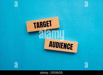 Target audience words written on wooden blocks with blue background. Conceptual target audience symbol. Copy space. Stock Photo