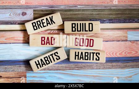 Symbol of good or bad habits. Concept of the word Good Habits Bad Habits on wooden blocks and beautiful vintage background. Stock Photo