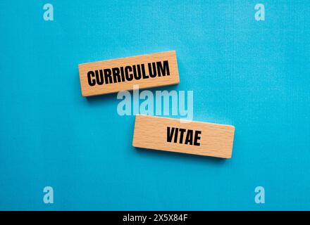 Curriculum vitae words written on wooden blocks with blue background. Conceptual curriculum vitae CV symbol. Copy space. Stock Photo