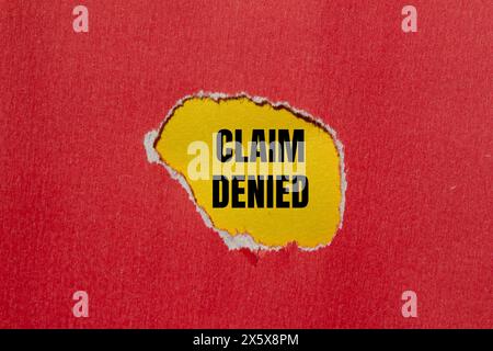 Claim denied words written on ripped red paper with yellow background. Conceptual claim denied symbol. Copy space. Stock Photo