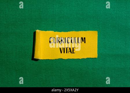 Curriculum vitae words written on ripped yellow paper with green background. Conceptual curriculum vitae symbol. Copy space. Stock Photo