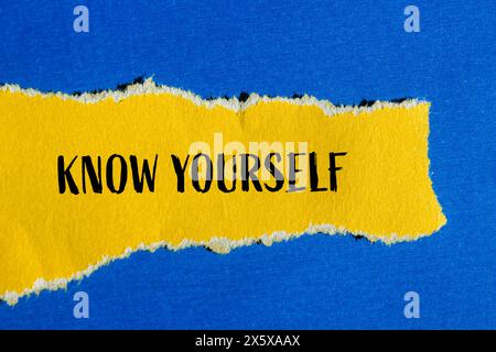 Know yourself words written on ripped yellow paper with blue background. Conceptual know yourself symbol. Copy space. Stock Photo