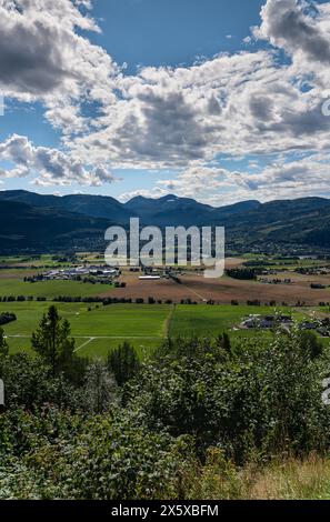 Summer Over Sylte and Surnadal: High Angle View Norwegian Farmlands. Verdant fields and rural homes nestled within mountain valley landscape in Norway Stock Photo