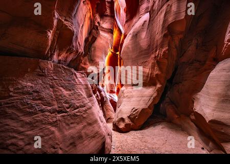 Antelope slot canyon near Page Arizona highlights the narrow passageway and amazing, glowing light and intricate patterns that form over millions of y Stock Photo