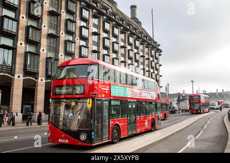 Westminster London, London red double decker buses on Bridge street passing New Parliamentary Building Portcullis House London,England,UK,2023 Stock Photo